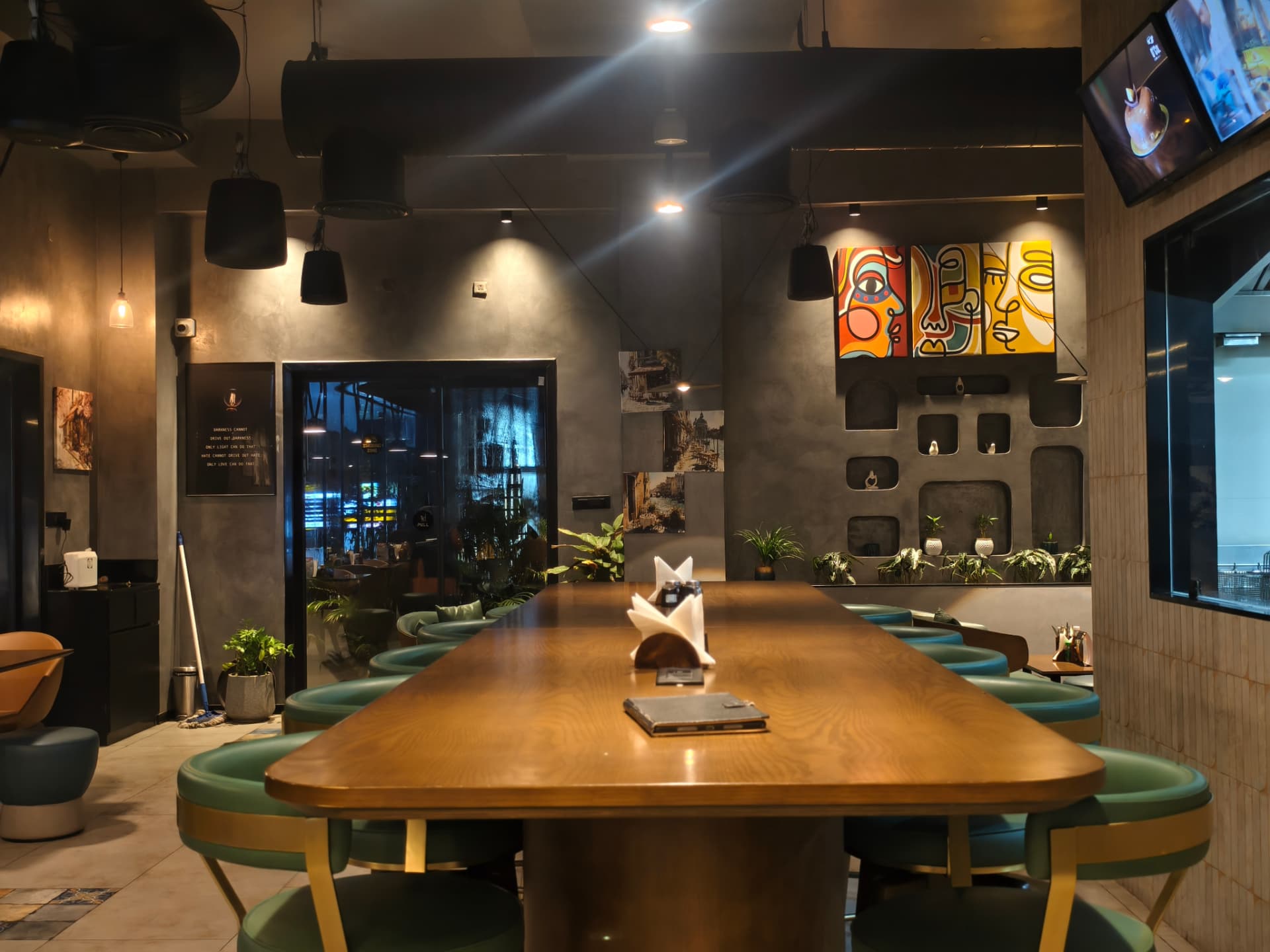 Tables and seating inside O’Co with warm pendant lighting