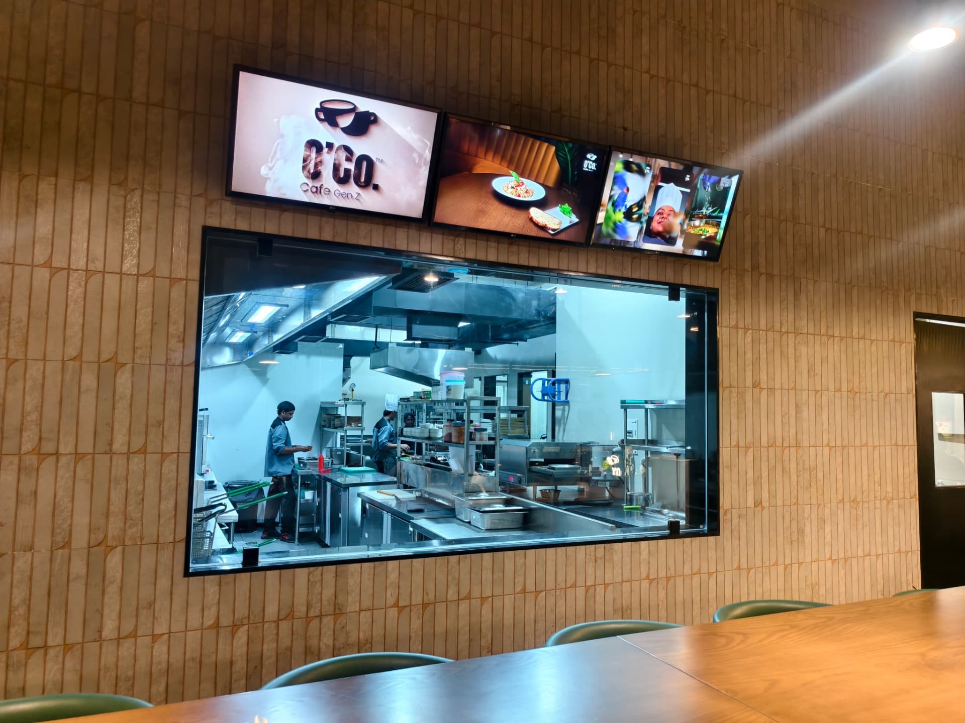 The open kitchen viewed through the window from O’Co’s dining area